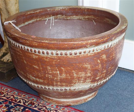 A brown glazed earthenware planter Diameter 62cm